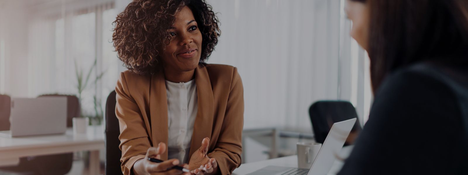 A young, professional woman assists a client 